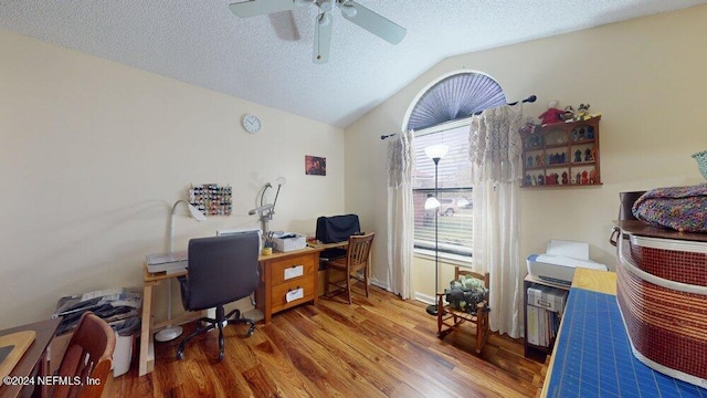 office space featuring lofted ceiling, hardwood / wood-style floors, a textured ceiling, and ceiling fan