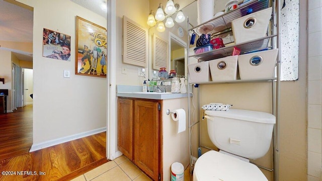 bathroom with vanity, hardwood / wood-style floors, and toilet