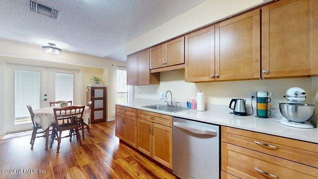 kitchen with french doors, sink, a textured ceiling, dark hardwood / wood-style flooring, and dishwasher