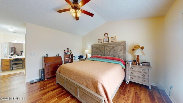 bedroom featuring dark hardwood / wood-style flooring, vaulted ceiling, and ceiling fan