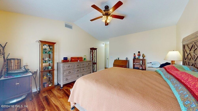 bedroom with ceiling fan, vaulted ceiling, and wood-type flooring