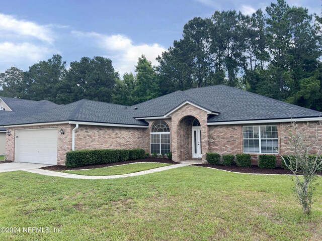 single story home with a garage and a front yard