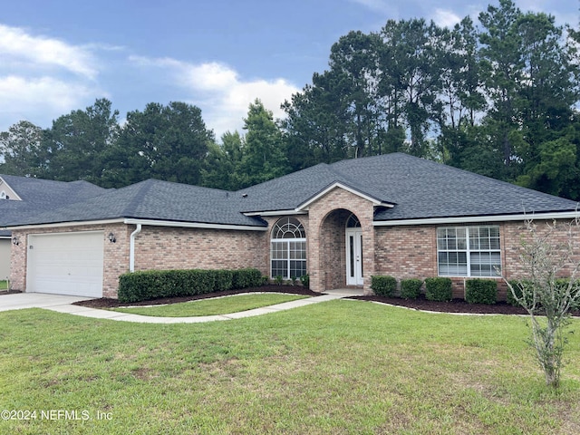 single story home with a garage and a front lawn