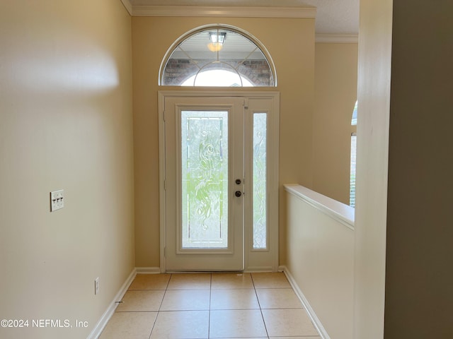 tiled foyer with crown molding and a wealth of natural light