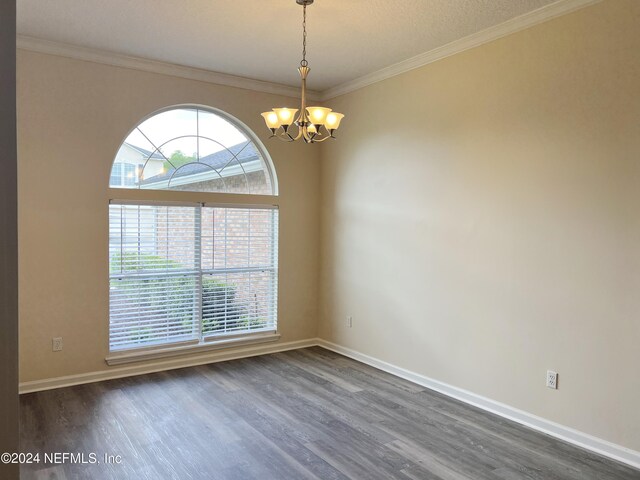 unfurnished room with a chandelier, crown molding, and dark wood-type flooring