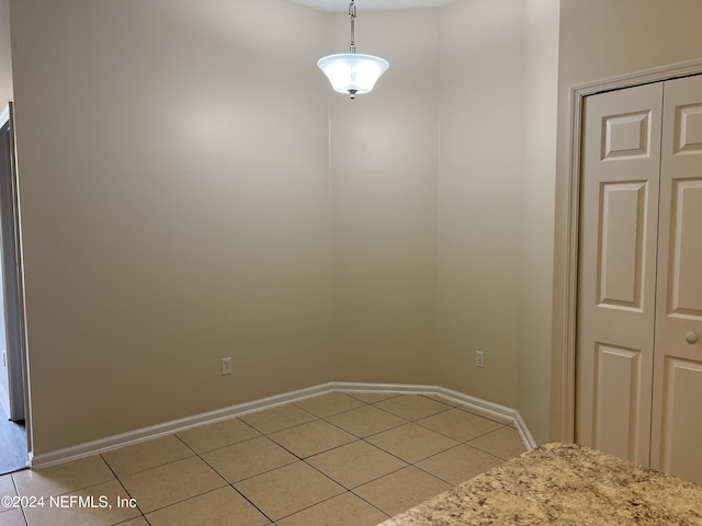 unfurnished dining area with light tile patterned floors