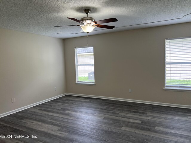 spare room with ceiling fan, a textured ceiling, hardwood / wood-style flooring, and a wealth of natural light