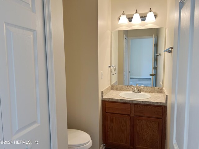 bathroom featuring vanity and toilet