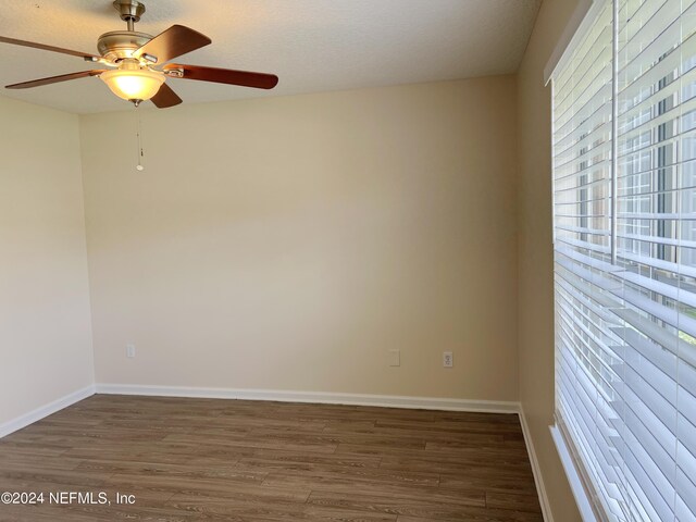 unfurnished room with hardwood / wood-style flooring and ceiling fan