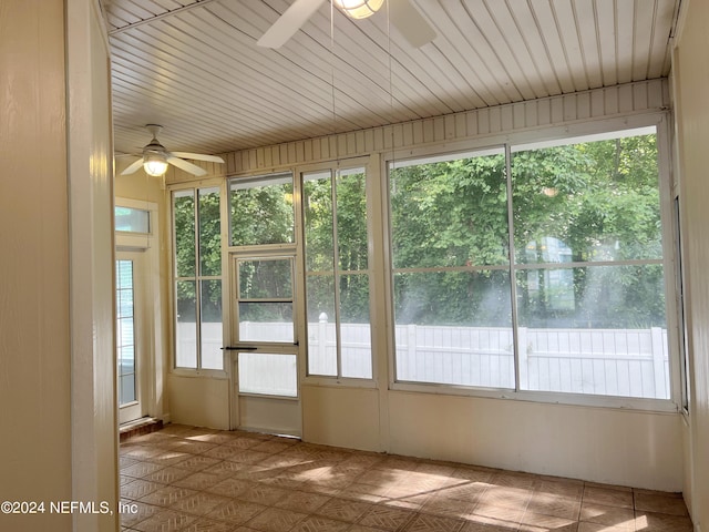 unfurnished sunroom with wooden ceiling and ceiling fan