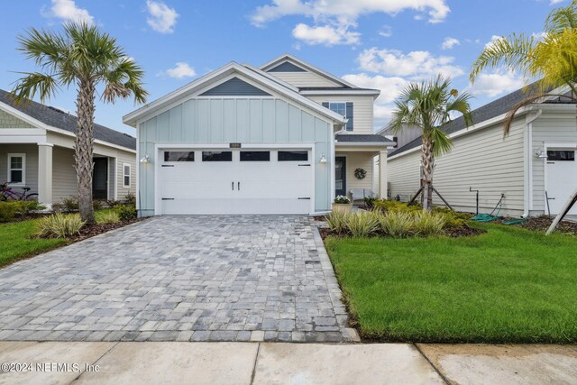 view of front facade with a front yard and a garage