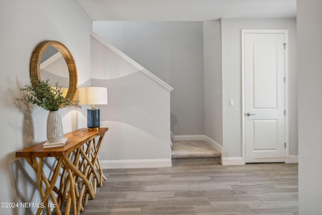 hallway with light hardwood / wood-style flooring