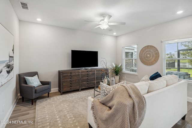 living room with hardwood / wood-style flooring and ceiling fan