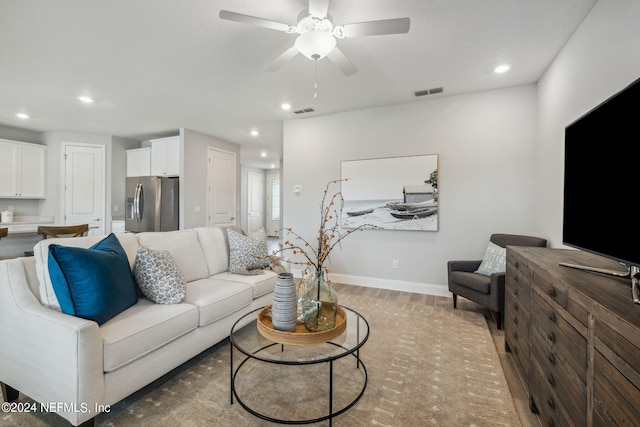 living room with ceiling fan and wood-type flooring