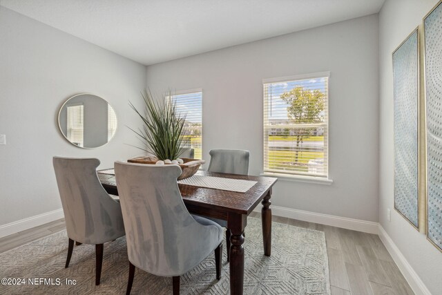 dining area featuring light wood-type flooring