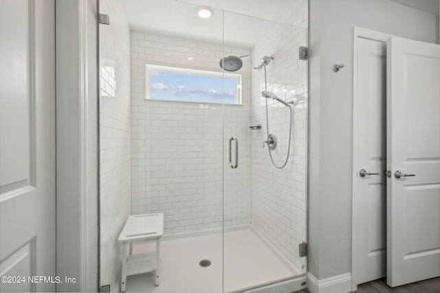 bathroom featuring a shower with shower door