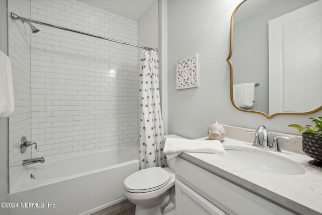 full bathroom featuring shower / bath combo with shower curtain, vanity, and toilet