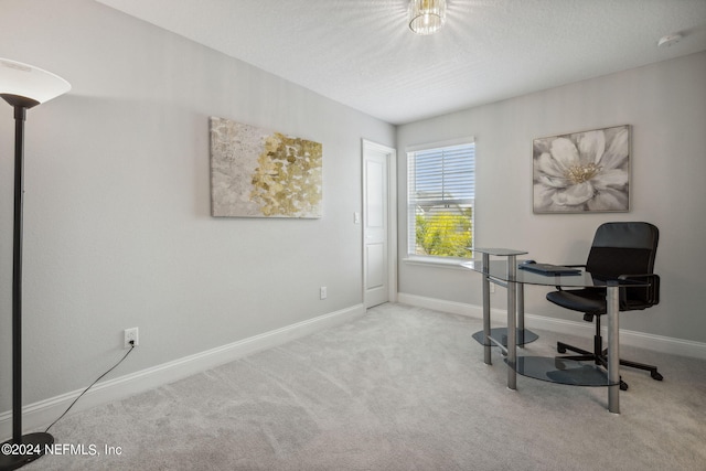 carpeted home office with a textured ceiling