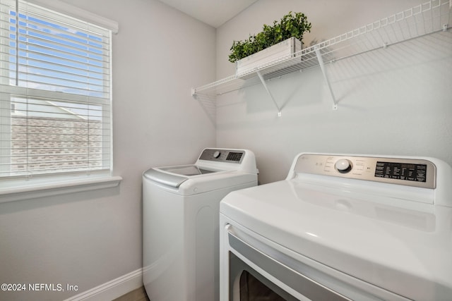 clothes washing area featuring separate washer and dryer