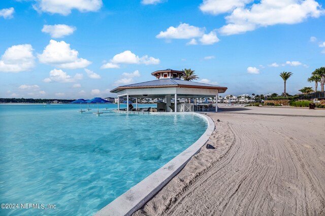 view of pool with a water view