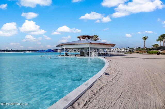 view of pool featuring a gazebo and a water view