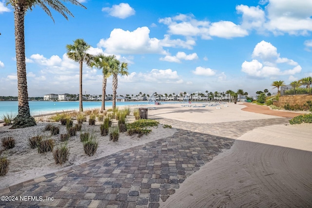 view of swimming pool with a view of the beach and a water view