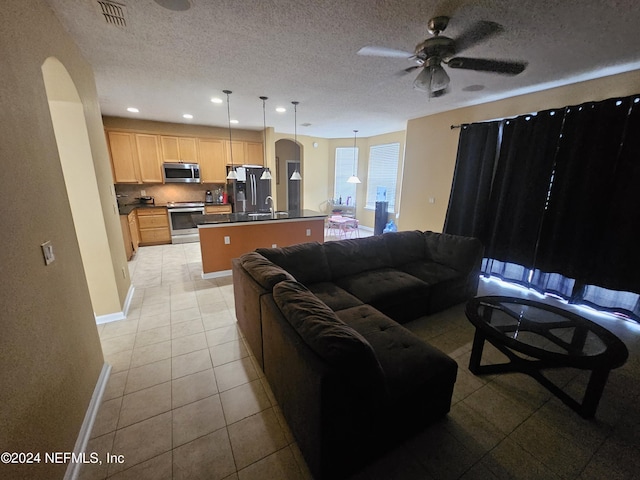 2727 Wood Stork Trl, Orange Park, FL 32073 - living room with visible vents, arched walkways, a textured ceiling, and ceiling fan