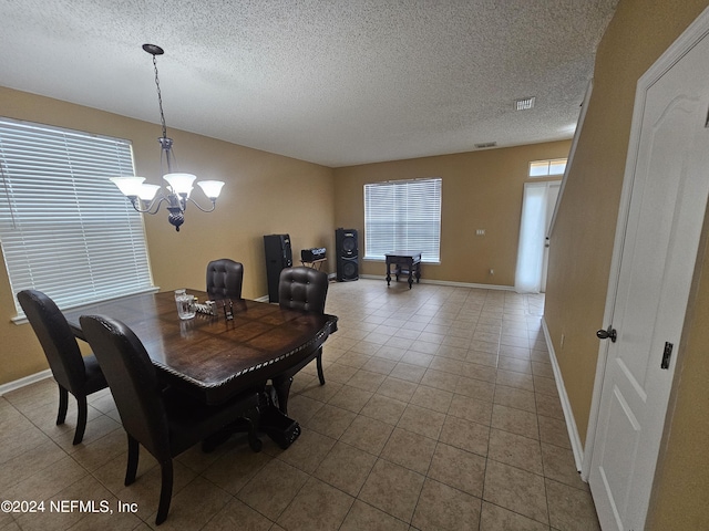 2727 Wood Stork Trl, Orange Park, FL 32073 - dining area with a notable chandelier, visible vents, baseboards, and a textured ceiling