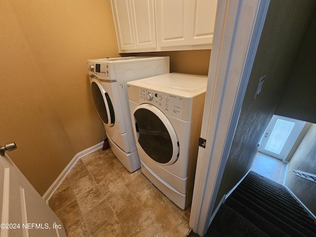 2727 Wood Stork Trl, Orange Park, FL 32073 - laundry area featuring cabinet space, washing machine and dryer, and baseboards