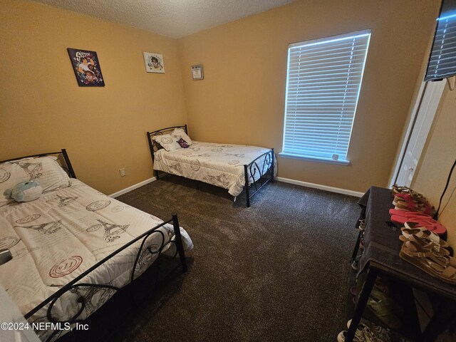 carpeted bedroom featuring a textured ceiling