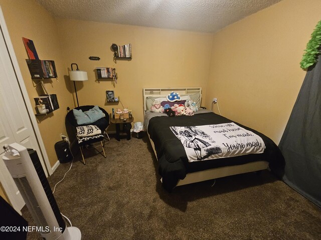 bedroom with carpet floors and a textured ceiling