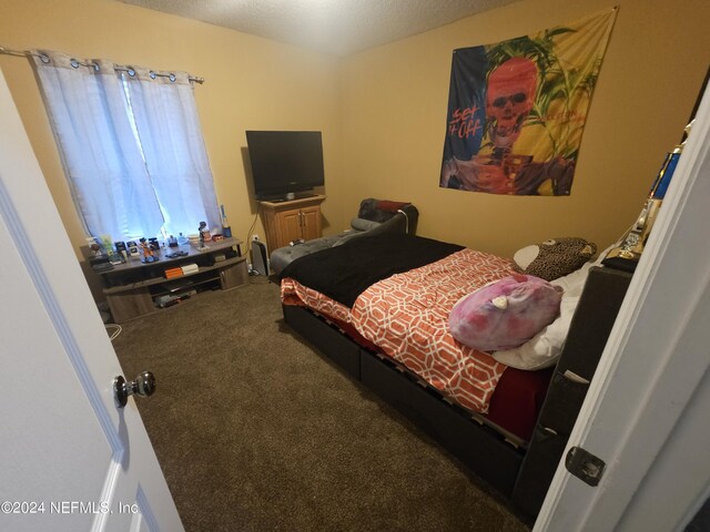 carpeted bedroom featuring a textured ceiling