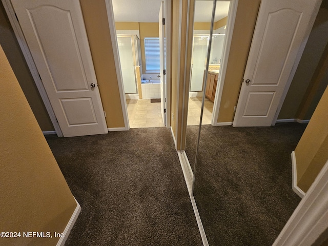 2727 Wood Stork Trl, Orange Park, FL 32073 - unfurnished bedroom with baseboards, dark carpet, and ensuite bathroom
