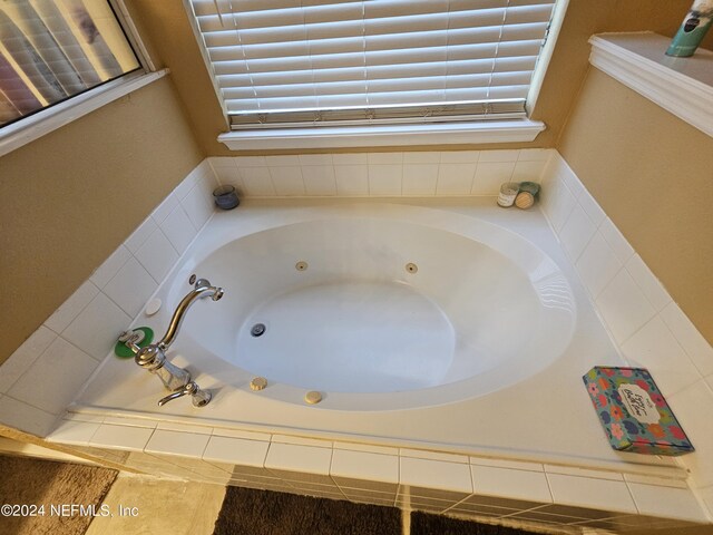 bathroom featuring tiled bath