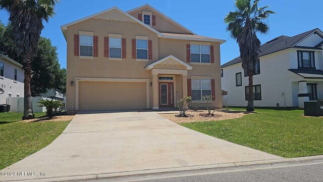 view of front of home featuring a garage, central AC, and a front yard