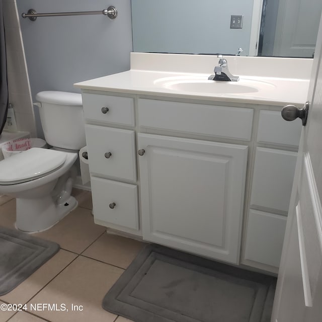 full bath with toilet, a shower with shower curtain, tile patterned flooring, and vanity