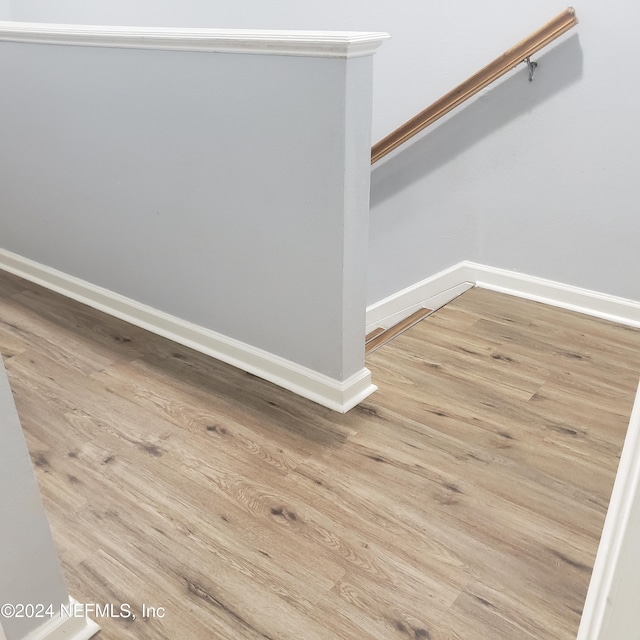 interior space with baseboards and wood finished floors