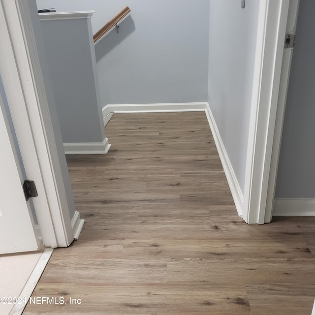 interior details featuring baseboards and wood finished floors