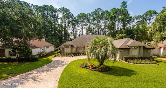 view of front of property with a front lawn and a garage