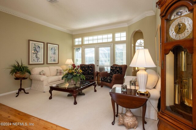 carpeted living room with crown molding