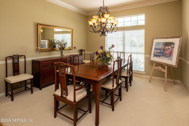 carpeted dining space with ornamental molding and a chandelier