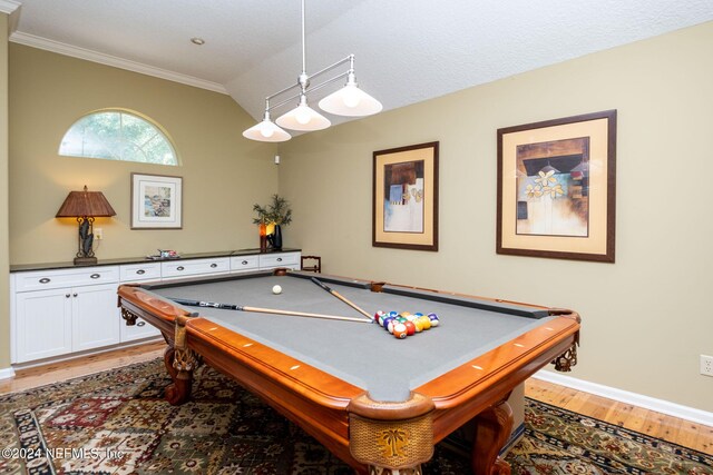 recreation room with lofted ceiling, a textured ceiling, pool table, light wood-type flooring, and ornamental molding