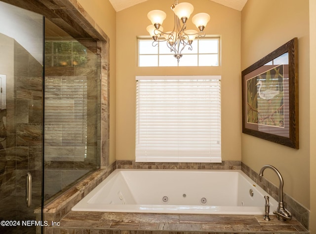 bathroom with a relaxing tiled tub, a chandelier, and vaulted ceiling