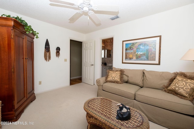 carpeted living room featuring ceiling fan