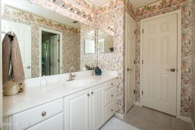 bathroom featuring tile patterned flooring and vanity