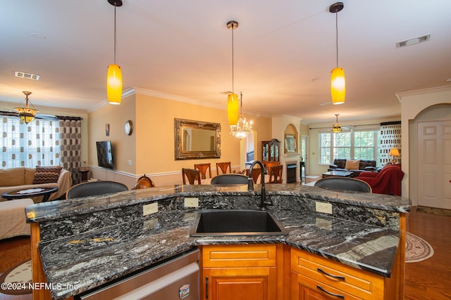 kitchen featuring open floor plan, stainless steel dishwasher, a sink, and visible vents