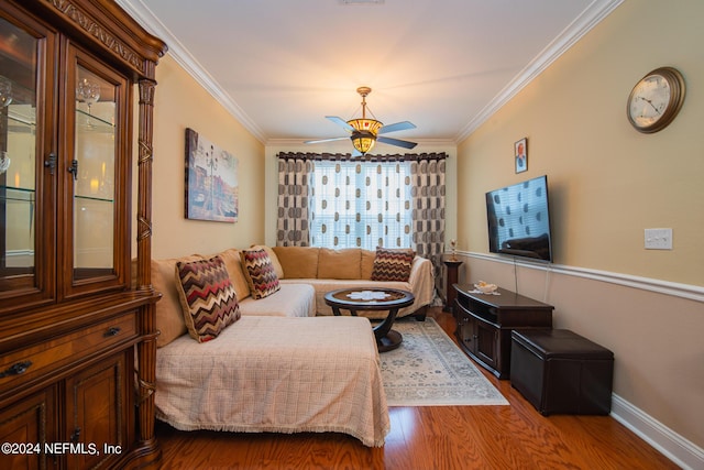 living room featuring a ceiling fan, baseboards, ornamental molding, and wood finished floors