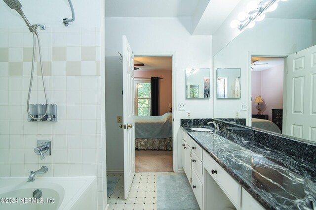 bathroom with vanity, tiled shower / bath, and tile patterned floors