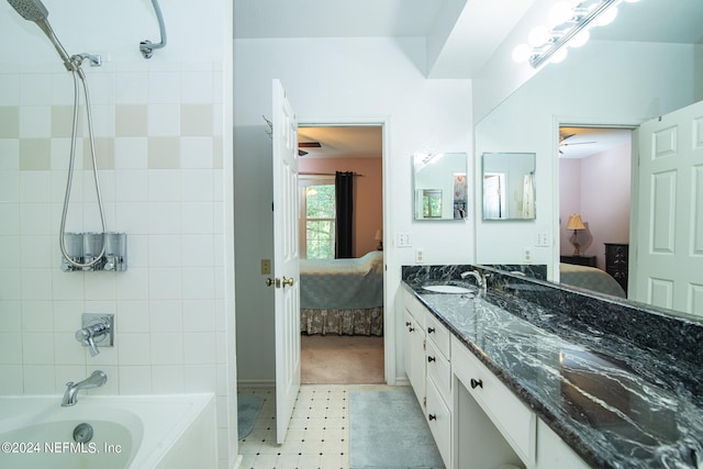 full bath with  shower combination, vanity, and ensuite bath