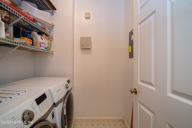 washroom with laundry area, light floors, washing machine and clothes dryer, and baseboards